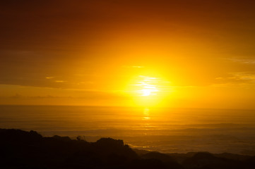 Fototapeta na wymiar Misty Sunset Over The Ocean