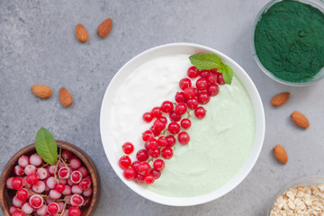 Healthy smoothie bowl with vegan protein, oat milk, frozen currants and mint. Breakfast smoothies