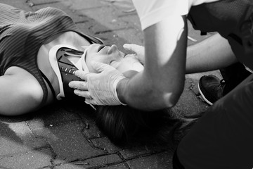Black and white photo of Close-up of a paramedic helping a car accident victim