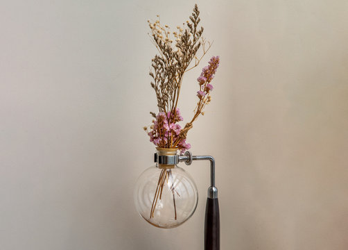 Beautiful dried flowers in a vintage glass vase for decoration at white brick background with empty wall with minimal Style. - Powered by Adobe