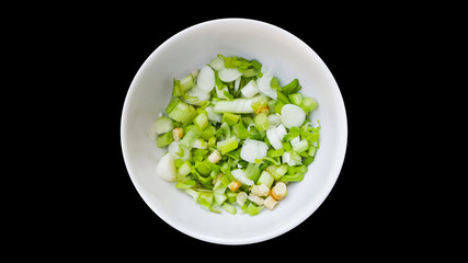 spring onions and coriander roots on white bowl isolated background