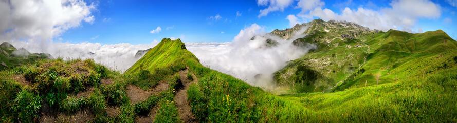 Panoramic majestic view on the Bavarian Alps and the Nebelhorn mountain with blue sky and white clouds