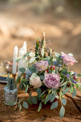 Obraz na płótnie Canvas Wedding table setting in rustic style in nature, decoration of glassware, fresh flowers and eucalyptus branches