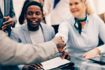 close up. smiling international business partners shaking hands