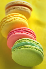 colorful macaroons on a yellow background dessert