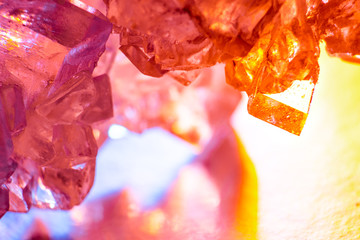 Abstract pink and yellow background with light sugar crystals is macro