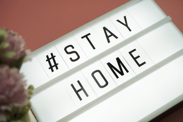 Stay Home word in light box on pink background