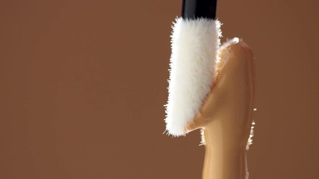 a concealer stick covered with light liquid concealer and a clean stick rub it. Concealer stick macro shoot