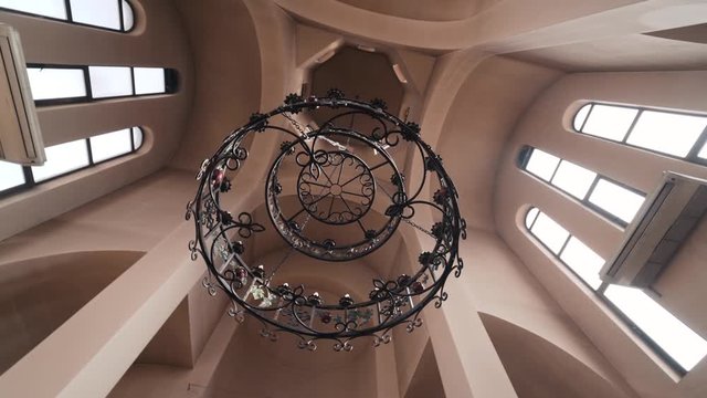 Large chandelier on the ceiling with handmade items, interior of the monastery of the Armenian Church.