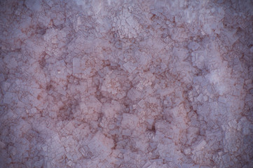 Beautiful crystals of pink salt at the bottom of a salt lake