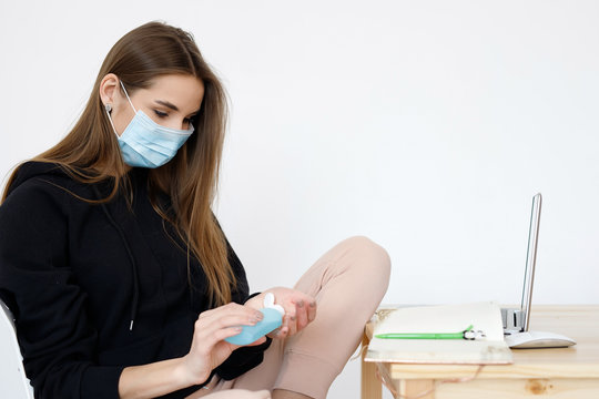 COVID-19 Pandemic Coronavirus Mask Woman Home Working. Girl wearing face mask smart home working on laptop computer - Powered by Adobe