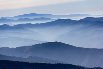 Naklejka na ściany i meble mountain peaks landscape with fog