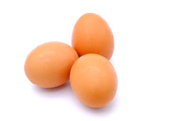 Close-up view of raw chicken eggs on background