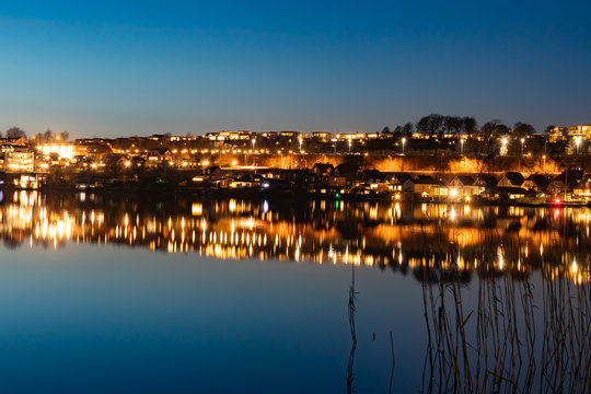 A beutiful water reflection of the city of Skanderborg in Denmark by night at a lake