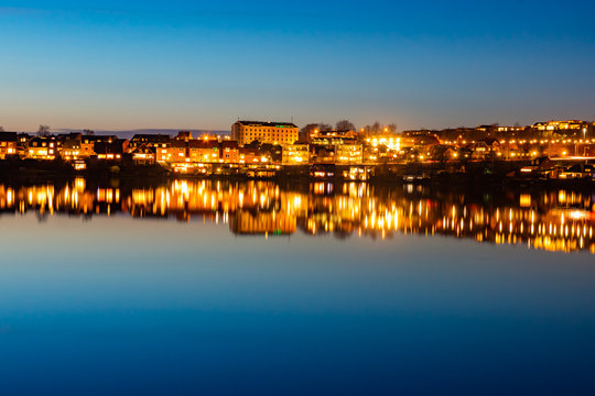 A beutiful water reflection of the city of Skanderborg in Denmark by night at a lake