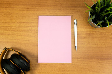 Stationery set with objects and a single empty pink notebook and withe empty pen for mockup purposes
