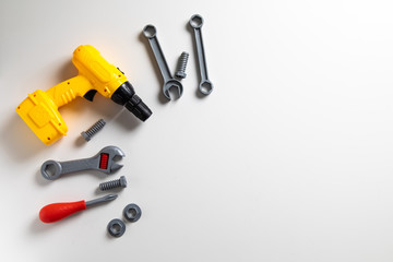 Top view. Plastic mechanic children Tool flat lay background. Space for text design. Mechanic Tools toy on white background