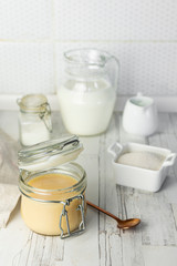 freshly prepared home-made condensed milk, on a light background