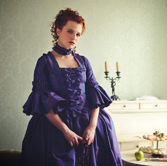 A gorgeous red-haired lady in a 18th century historical dress