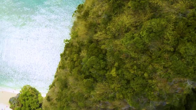 spinning scary drone shot of mountain in the ocean, Thailand