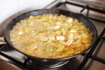 Tofu with vegetables in a pan.