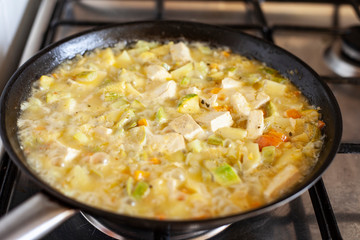 Tofu with vegetables in a pan.