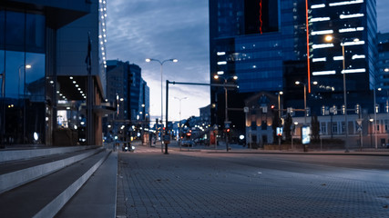 Shot of Modern Business District Area in the Evening. Atmospheric Dark Urban City Lights in the Background.