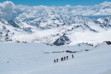 Fototapeta na wymiar Caucasian mountains. A group of climbers climbs the mountain.