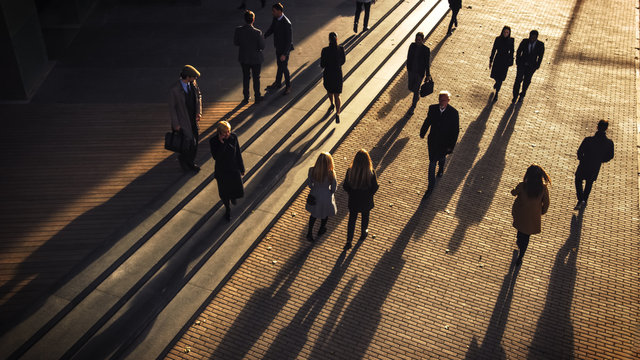 Office Managers And Business People Commute To Work In The Morning Or From Office On A Sunny Day On Foot. Pedestrians Are Dressed Smartly. Successful People Walking In Downtown. Shot From Above.