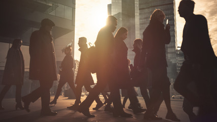 Office Managers and Business People Commute to Work in the Morning or from Office on a Sunny Day on Foot. Pedestrians are Dressed Smartly. Successful People Holding Smartphones. Sunny Day in Downtown