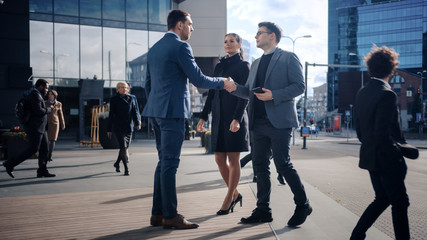 Multicultural Diverse Office Managers and Business People Walking on a Street. Female and Male Meet a Corporate Partner next to Business Center and Shake Hands.