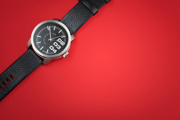 Modern male watch on red background