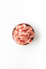 Shrimps in shell in bowl on white background top-down copy space