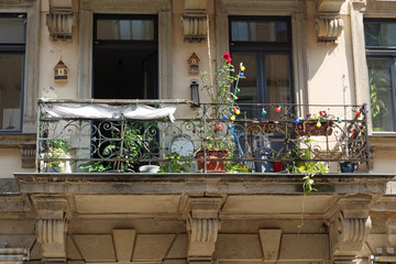 Close-up of a beautifully with plants, light bulbs and insect houses decorated balcony in the Neustadt of Dresden, Germany, Europe

