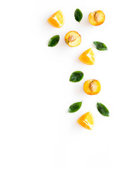 Peach slices and leaves pattern on white background top-down frame copy space