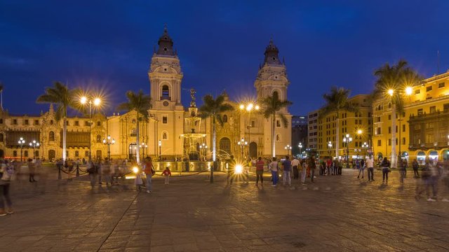 Fountain on The Plaza de Armas day to night transition timelapse, also known as the Plaza Mayor, sits at the heart of Lima's historic center. Illuminated cathedral on a background