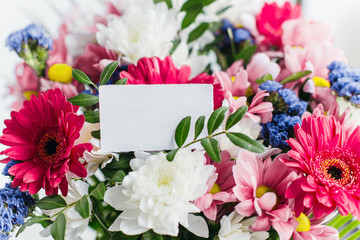 white gift card in a bouquet of flowers 