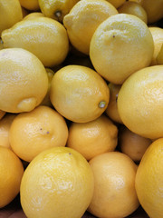 Yellow whole lemons background, from supermarket