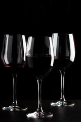 Red wine glasses on black background