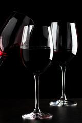 Red wine glasses on black background
