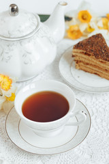 Tea in a white mug close-up on a white background