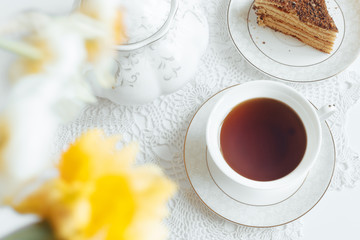 Tea in a white mug close-up on a white background