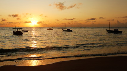 A beautiful sunrise between boats