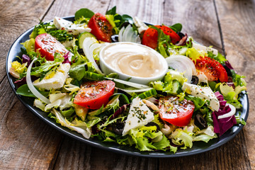Fresh salad - blue cheese and vegetables on wooden table
