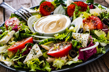 Fresh salad - blue cheese and vegetables on wooden table
