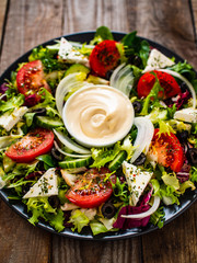 Fresh salad - blue cheese and vegetables on wooden table
