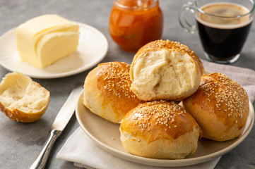 Homemade fresh buns served with butter and apricot jam.