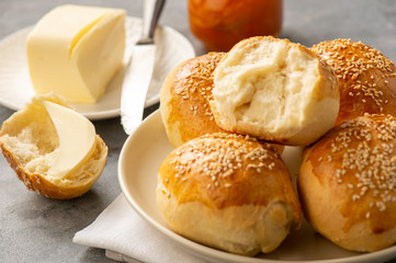 Homemade fresh buns served with butter and apricot jam.