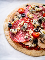 Uncooked pizza on white paper