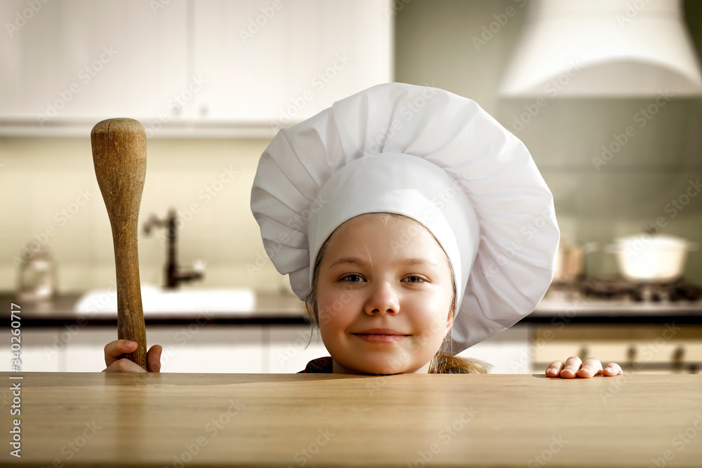 Poster kid in kitchen and cook hat